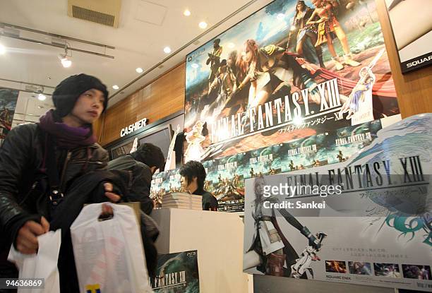 Customers purchase Square Enix Holdings Co.'s "Final Fantasy XIII" role-playing video game at a launch event in the Sibuya district on December 17,...