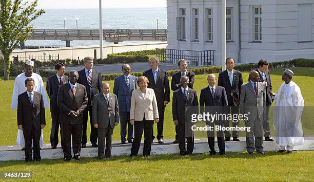 Leaders and Outreach representatives pose for a group photograph, front row, from left, French President Nicolas Sarkozy, Ghanaian President John...