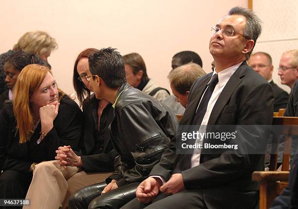 Jacob "Kobi'' Alexander, right, the former Comverse Technology Inc. Chief executive officer, flanked by his wife Hana, left, wait at the magistrates...