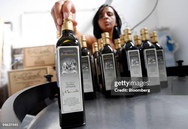 Employee Antonella Murgia arranges bottles of L'Olio d'Oliva Di Bennardo olive oil at the company's factory in Sambuca di Sicilia, Sicily, Italy,...