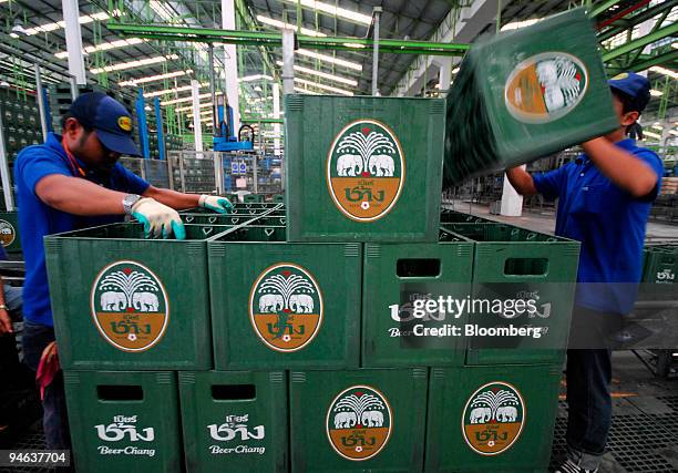 Workers stack beer crates at a Thai Beverage Plc Chang brewery in Kamphaeng Phet, north of Bangkok on Monday, May 22, 2006.