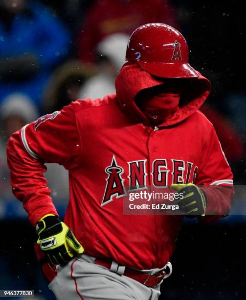Alfredo Griffin first base coach of the Los Angeles Angels of Anaheim runs to the dugout after the seventh inning against the Kansas City Royals at...