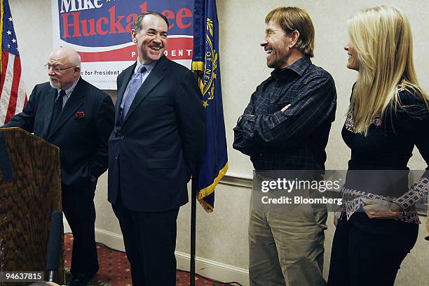 Republican presidential candidate and former Arkansas Governor Mike Huckabee, center, shares a laugh with Actor Chuck Norris, second from right, and...
