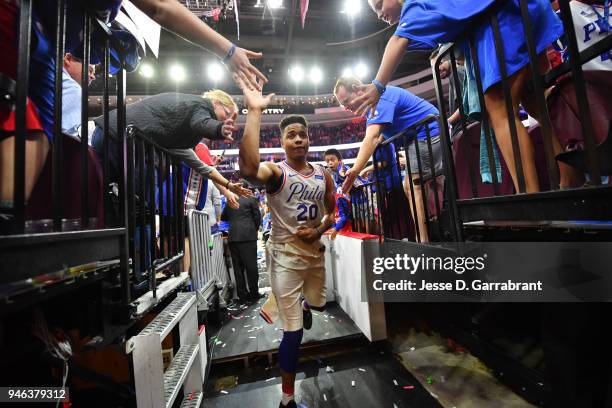 Markelle Fultz of the Philadelphia 76ers exchange high fives with fans after game one of round one of the 2018 NBA Playoffs against the Miami Heat on...