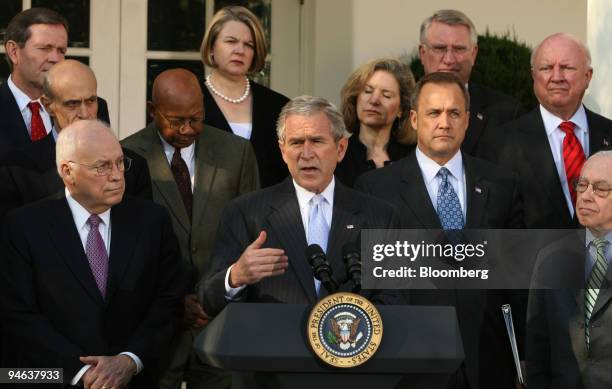 President George W. Bush, backed by members of his cabinet, makes a statement from the Rose Garden of the White House in Washington, D.C., U.S., on...