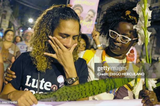 Anielle Silva , sister of activist Marielle Franco, cries at a memorial in Rio de Janeiro on April 14 one month after her murder in Lapa. The murder...