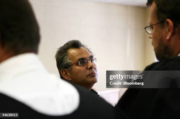 Jacob ``Kobi'' Alexander, center, the former Comverse Technology Inc. Chief executive officer talks with his lawyers at the magistrates court in...