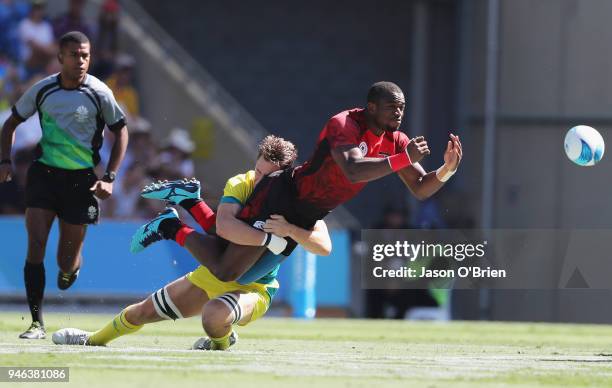 Kenya's Willie Ambaka throws a pass against Australia during Rugby Sevens on day 11 of the Gold Coast 2018 Commonwealth Games at Robina Stadium on...