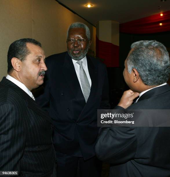 Shokri Ghanem, chairman of the Peoples Committee, The National Oil Company of Libya, left, chats with Desiderio Costa, Angola's Oil Minister, center,...