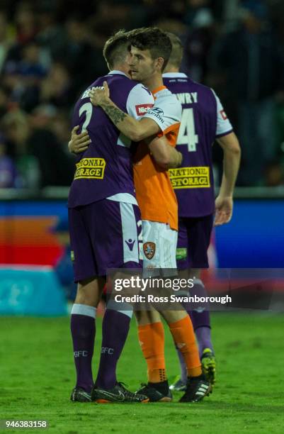 Alex Grant of the Glory hugs Mitchell Oxborrow as the Roar wins at nib Stadium on April 14, 2018 in Perth, Australia.