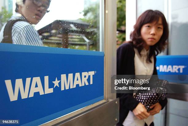 Customers enter a Wal-Mart SuperCenter in Bucheon, South Korea on Monday, May 22, 2006. South Korean consumers became the most optimistic in five...