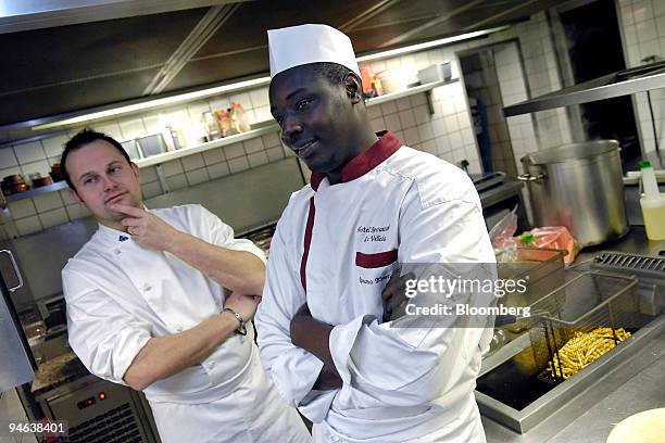 Chef de cuisine, Thierry Grandgeorge, left, and Koutoubo Gassama, an immigrant from Senegal who works as a cook in the Hotel Restaurant Velleda,...