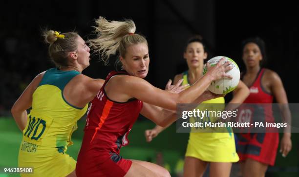 Australia's Gabi Simpson and England's Chelsea Pitman in action in the Women's Netball gold medal match at the Coomera Indoor Sports Centre during...