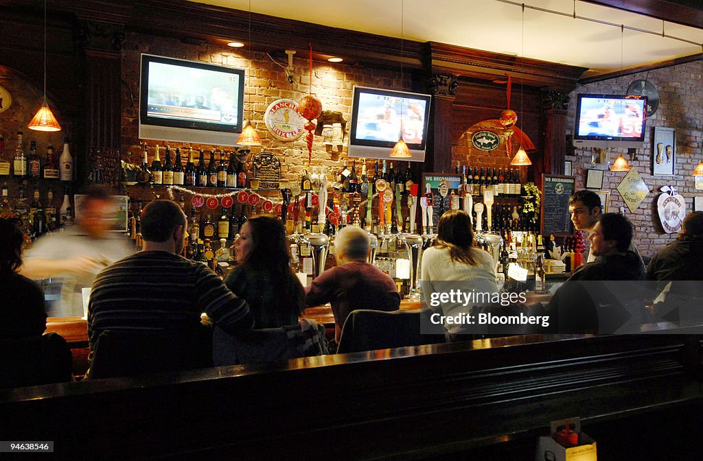 Patrons sit at the bar at the Downtown Bar and Grill in the