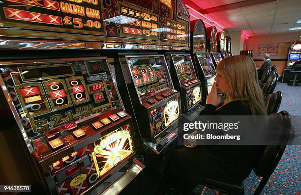 Woman smokes while playing slot machines at Beacon Bingo in Cricklewood Broadway, north London, on Wednesday, December 13, 2006. Bingo parlors, once...