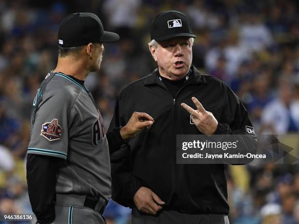 Umpire Brian Gorman explains the ruling on the field to overturn a home run call to manager Torey Lovullo of the Arizona Diamondbacks in the fourth...