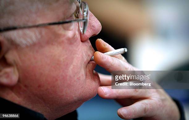 Man smokes while playing bingo at Beacon Bingo in Cricklewood Broadway, north London, on Wednesday, December 13, 2006. Bingo parlors, once the realm...