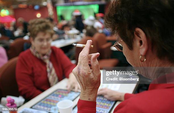 Woman smokes while playing bingo at Beacon Bingo in Cricklewood Broadway, north London, on Wednesday, December 13, 2006. Bingo parlors, once the...