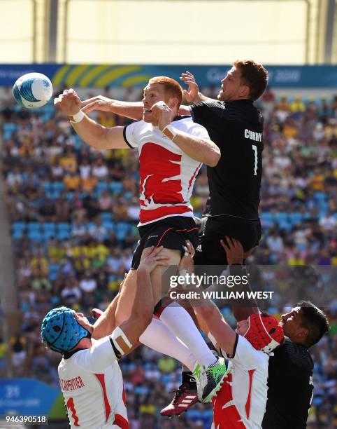 England's Philip Burgess contests the lineout ball with New Zealand's Scott Curry in their men's rugby sevens semi-final match at the Robina Stadium...