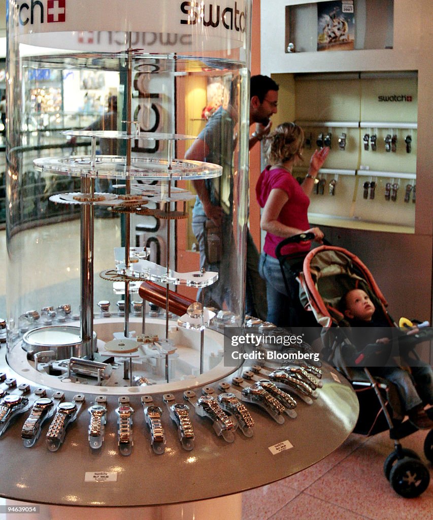 A couple looks over a display of watches in Valencia, Venezu