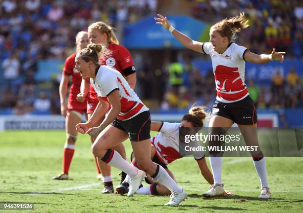 England's players celebrate winning against Canada in the women's rugby sevens bronze medal match at the Robina Stadium during the 2018 Gold Coast...