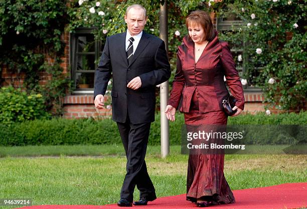 Russian President Vladimir Putin, left, arrives with his wife Lyudmila Putin for the G-8 dinner at Gut Hohen Luckow near Bad Doberan, Germany,...