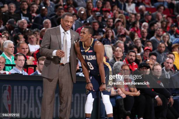 Coach Alvin Gentry of the New Orleans Pelicans speaks with Rajon Rondo during the game against the Portland Trail Blazers in game one of Round One of...