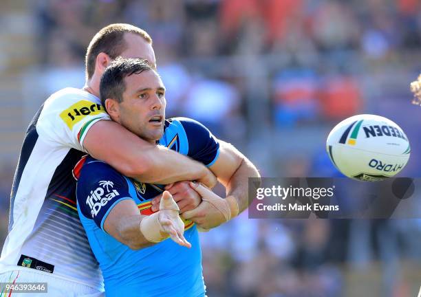 Michael Gordon of the Titans offloads the ball as he is tackled by Isaac Yeo of the Panthers during the round six NRL match between the Penrith...