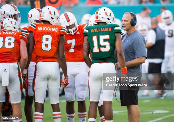 University of Miami Hurricanes Head Coach Mark Richt talks with University of Miami Hurricanes Quarterback Jarren Williams in the huddle with...