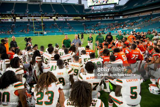 University of Miami Hurricanes Head Coach Mark Richt talks with offensive players and the defensive players on the field after the University of...