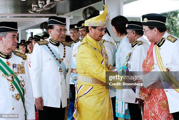 Abdullah Ahmad Badawi, prime minister of Malaysia, left, and Rais Yatim, Malaysian minister of Arts, Culture and Heritage, second from left, look on...