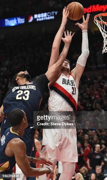 Anthony Davis of the New Orleans Pelicans and Jusuf Nurkic of the Portland Trail Blazers go up for a rebound during the second half of game one of...