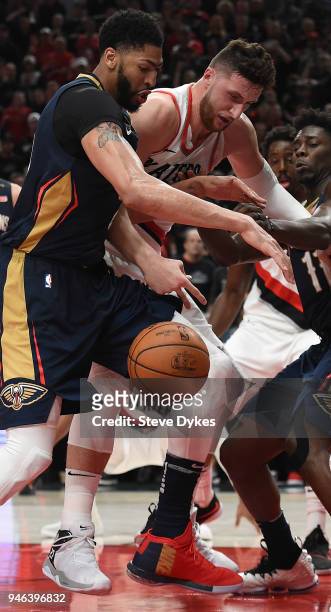 Anthony Davis of the New Orleans Pelicans and Jusuf Nurkic of the Portland Trail Blazers battle for a loose ball during the second half of game one...
