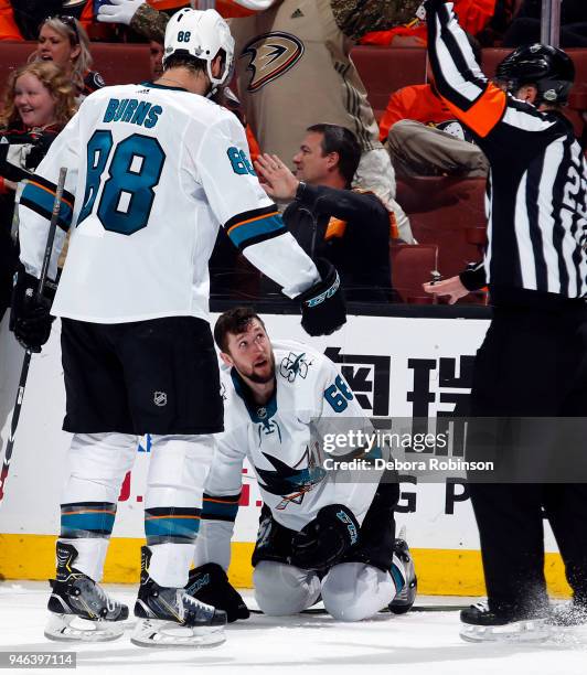 Brent Burns of the San Jose Sharks checks on Melker Karlsson after a hit in Game Two of the Western Conference First Round against the Anaheim Ducks...