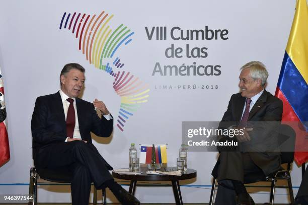 Colombian President Juan Manuel Santos chats with President of Chile Sebastian Pinera during the VIII Summit of the Americas in Lima, Peru on April...