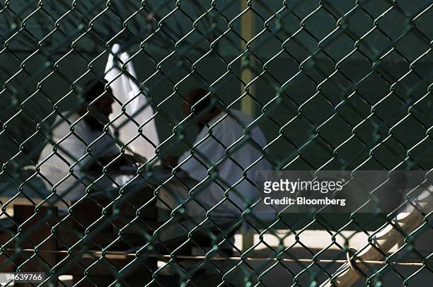 Two detainees sit at a table at Camp Delta at the U.S. Naval Station in Guantanamo Bay Cuba, Tuesday, December 12, 2006. The US Department of Defense...