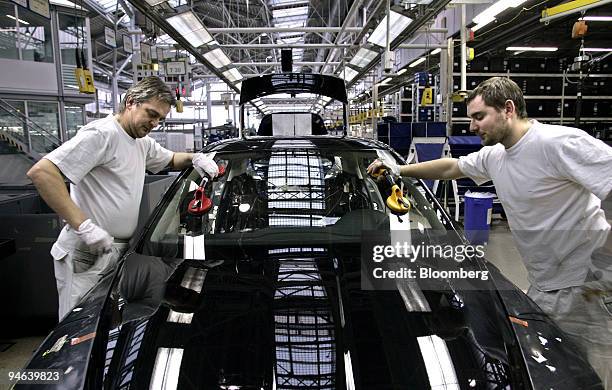 Auto workers set window glass on an assembly line at the factory headquarters of Skoda Auto S.A.. In Mlada Boleslav, Czech Republic, on Tuesday,...