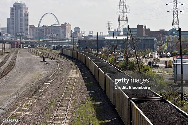 Train cars filled with coal sit on the railroad tracks near St. Louis, Missouri on April 19, 2007. The St. Louis Arch is seen in the distance. Union...