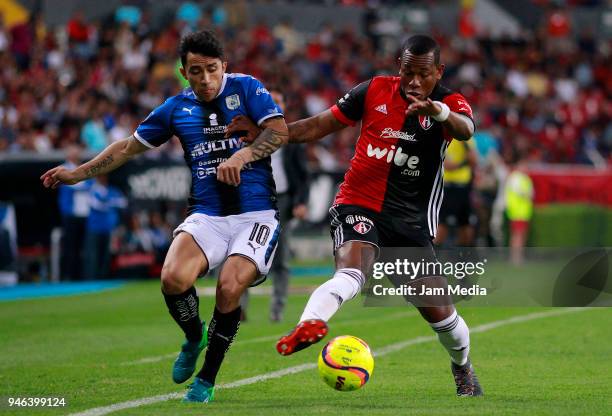 Edson Puch of Queretaro and Leiton Jimenez of Atlas fight for the ball during the 15th round match between Atlas and Queretaro at Estadio Jalisco on...