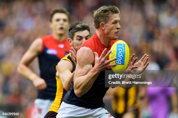 Sam Frost of the Demons is tackled by Ricky Henderson of the Hawks during the round four AFL match between the Hawthorn Hawks and the Melbourne...