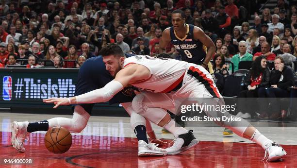 Jusuf Nurkic of the Portland Trail Blazers scrambles for a ball with Nikola Mirotic of the New Orleans Pelicans as Rajon Rondo looks on during the...