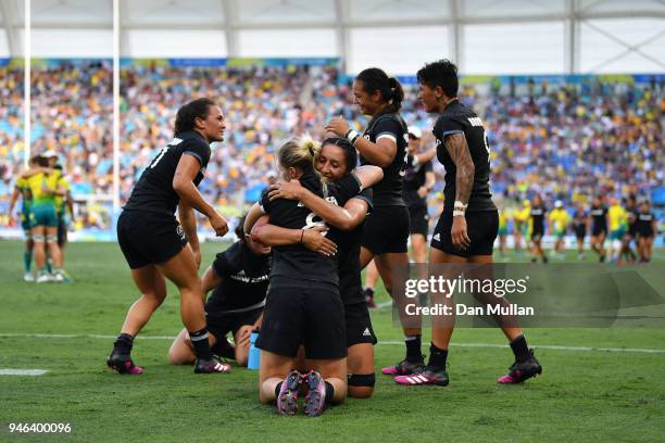 New Zealand Kelly Brazier is congratulated by team mates after scoring the winning try in the Women's Gold Medal Rugby Sevens Match between Australia...