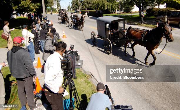 Horse and buggy funeral procession for Naomi Ebersole, one of the victims from the Amish school shooting, makes it way to the cemetery, Thursday,...