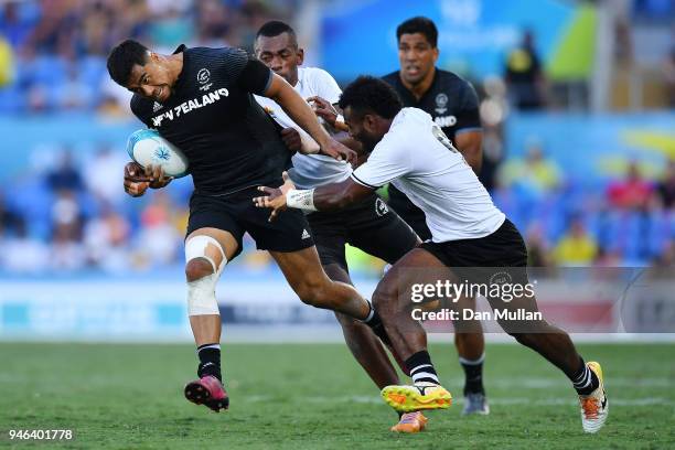 New Zealand Regan Ware is tackled in the Men's Gold Medal Rugby Sevens Match between Fiji and New Zealand on day 11 of the Gold Coast 2018...