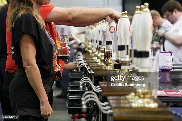 Bartender holds a drink at the Great British Beer Festival 2006, in London, U.K., on Thursday, August 3, 2006. The festival, with more than 450 types...