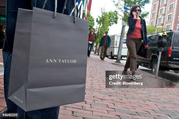 Customer stands outside an Ann Taylor store in Cambridge, Massachusetts, Friday, May 19, 2006. AnnTaylor Stores Corp., the women's clothing retailer,...