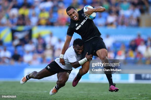 New Zealand Sione Molia is tackled by Fiji Jerry Tuwai in the Men's Gold Medal Rugby Sevens Match between Fiji and New Zealand on day 11 of the Gold...