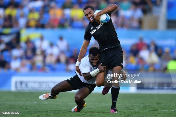 New Zealand Sione Molia is tackled by Fiji Jerry Tuwai in the Men's Gold Medal Rugby Sevens Match between Fiji and New Zealand on day 11 of the Gold...