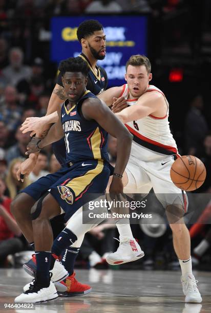 Jrue Holiday of the New Orleans Pelicans and Pat Connaughton of the Portland Trail Blazers go after a ball as Anthony Davis of the New Orleans...