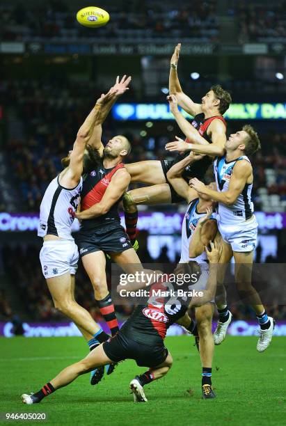 Joe Daniher of the Bombers flys high into the backs of Tom Bellchambers of the Bombers and Charlie Dixon of Port Adelaide during the round four AFL...